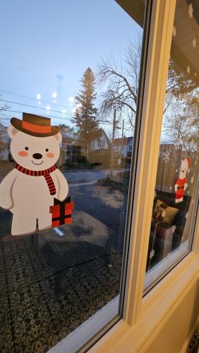 a window with a snowman decoration on it at Serenity Inn in Niagara Falls