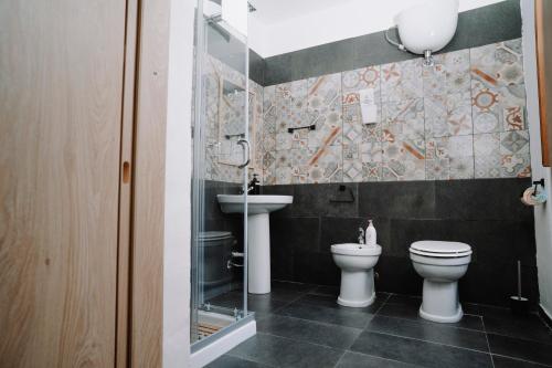 a bathroom with a toilet and a sink at Bonne Nuit Terracina in Terracina