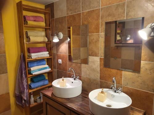 a bathroom with two sinks and a mirror and towels at PYZÓWKA - agroturystyka, dom na zaciszu, imprezy in Raków