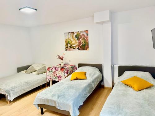 a room with two beds and a painting on the wall at Apartament nr 1 lub 2 przy Sali Kominkowej in Przeczyce