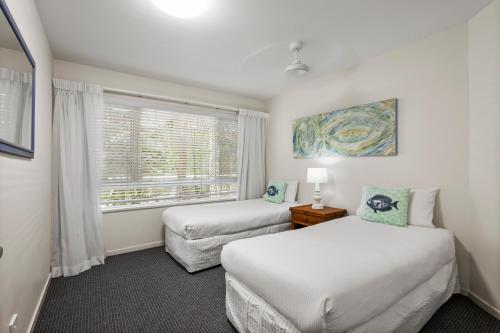 a hotel room with two beds and a window at Sunshine Vista in Sunshine Beach