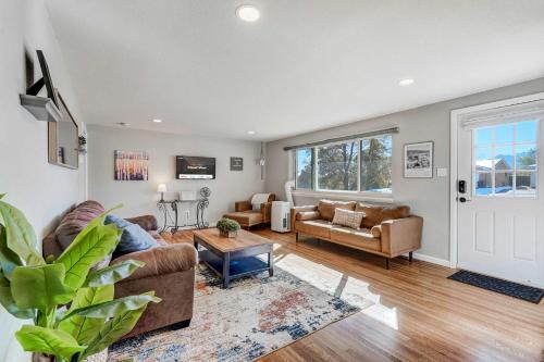 a living room with a couch and a table at Cloud View Family Mountain Views & Fire Pit in Colorado Springs