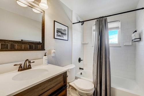 a white bathroom with a sink and a toilet at Cloud View Family Mountain Views & Fire Pit in Colorado Springs