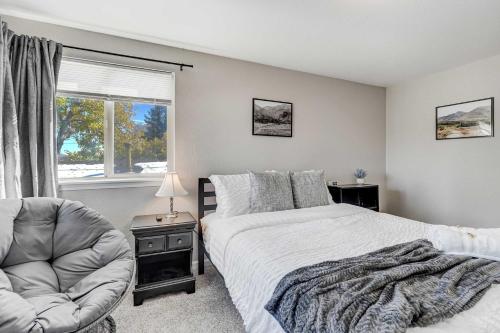 a bedroom with a bed and a chair and a window at Cloud View Family Mountain Views & Fire Pit in Colorado Springs