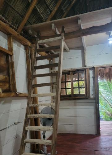 a wooden ladder in a room with a window at Coconut Surf in El Gigante