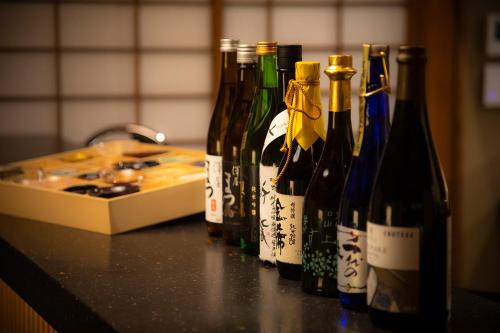 a group of bottles of wine sitting on a counter at Hotel Utano Kyoto Besho in Kyoto