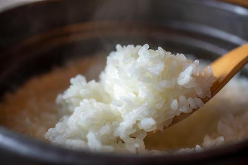 a wooden spoon full of rice in a pan at Hotel Utano Kyoto Besho in Kyoto