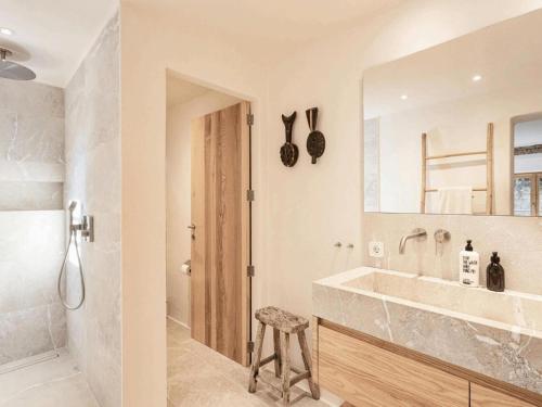 a bathroom with a tub and a sink and a stool at Villa in Andratx with Sea Views and Pool in Andratx