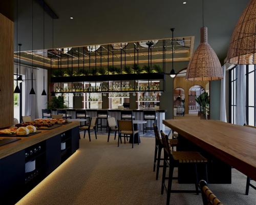 a restaurant with a bar with tables and chairs at Secrets Playa Esmeralda Resort & Spa - All Inclusive in Miches