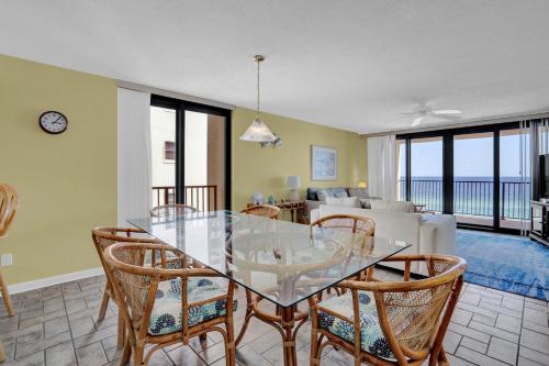 a dining room with a glass table and chairs at Wind Drift 501 by Vacation Homes Collection in Orange Beach