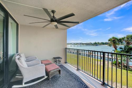 a balcony with two chairs and a ceiling fan at Wind Drift 114 North by Vacation Homes Collection in Orange Beach