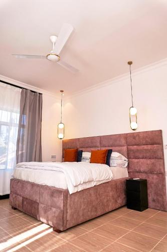 a bedroom with a large bed in a room at Boha Zanzibar Beach House in Bwejuu