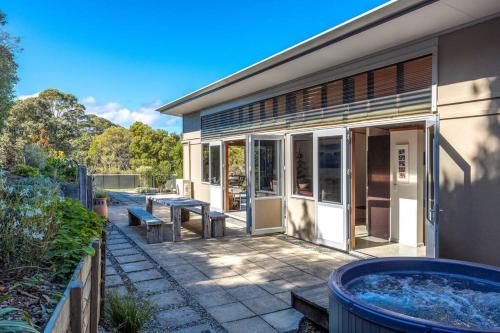 a building with a hot tub in front of it at Welcome on Wilma by Waiheke Pure in Waiheke Island