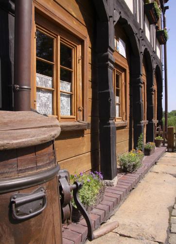 a building with some flowers in front of it at Zagroda Kołodzieja in Zgorzelec
