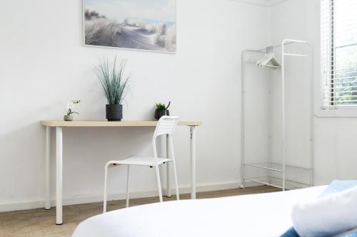 a room with a desk with two white chairs at Private Double Room - Central Location at Ryde - Shared Bathroom in Sydney