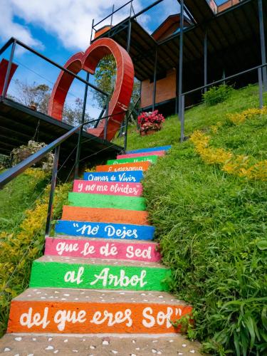a set of stairs with writing on them in front of a building at La Finca De Frida in Guatapé