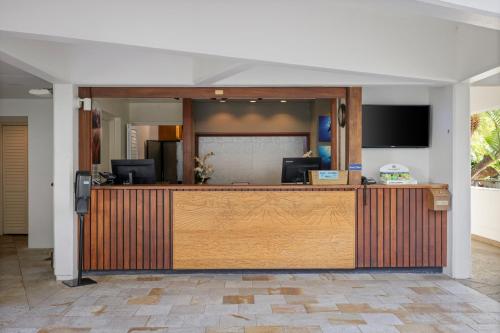 a lobby with a reception desk with a television at Royal Sea Cliff Kona by OUTRIGGER in Kailua-Kona