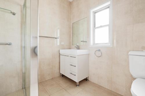 a bathroom with a toilet and a sink and a shower at Bright Queen Room - Central Location at Ryde - Shared Bathroom in Sydney