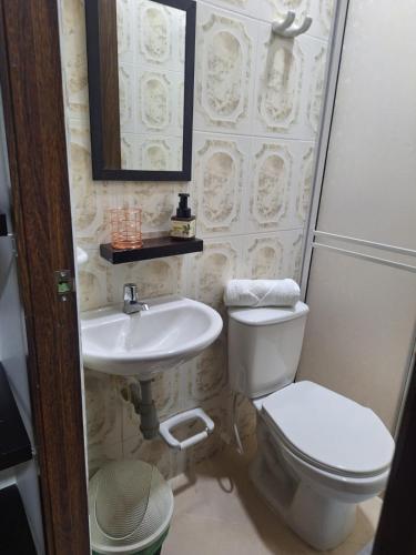 a bathroom with a toilet and a sink at Hotel Casa Real Málaga Santander in Málaga