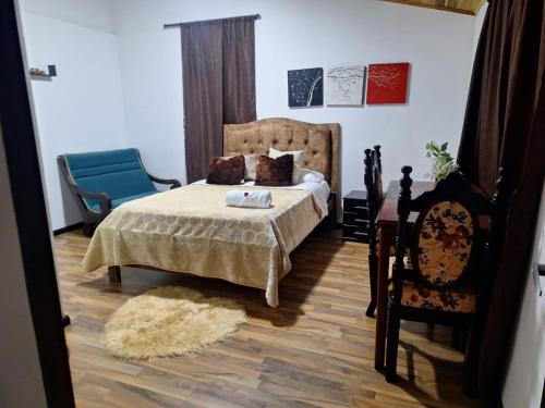 a bedroom with a bed and a chair at Hotel Casa Real Málaga Santander in Málaga