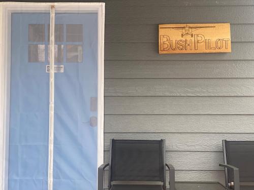 a front door of a house with a sign on it at Talkeetna Bush Pilot House in Talkeetna