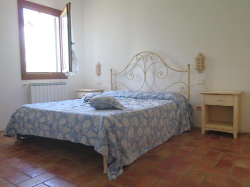 a bedroom with a bed with a blue comforter at Tenuta Lio Maggiore in Lido di Jesolo