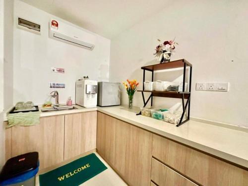 a kitchen with a counter with a sink and a microwave at Well Hotel by UHA in Johor Bahru