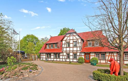 a red and white house with a red roof at Ferienwohnung Südmüritz in Vipperow