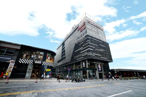 a tall building on a street in a city at Super Time Trendy Design Hotel Guangzhou Beijing Road Pedestrian Street Dafo Temple Branch in Guangzhou
