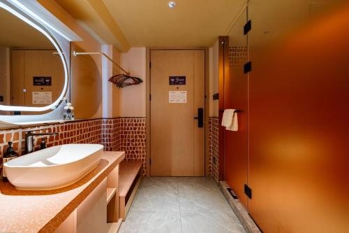 a bathroom with a sink and a shower at Super Time Trendy Design Hotel Guangzhou Beijing Road Pedestrian Street Dafo Temple Branch in Guangzhou