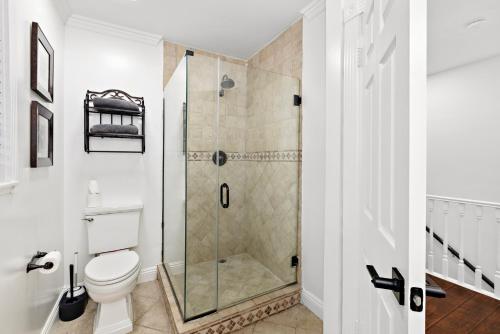 a bathroom with a shower and a toilet at Villa Oasis: Unrivaled Views & Endless Space in Los Angeles
