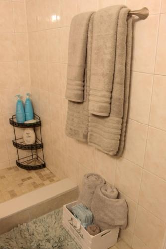 a bathroom with white towels and a sink and a tub at Beach Escape private studio in Sunny Isles Beach