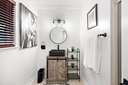 a bathroom with a sink and a mirror at Villa Oasis: Unrivaled Views & Endless Space in Los Angeles
