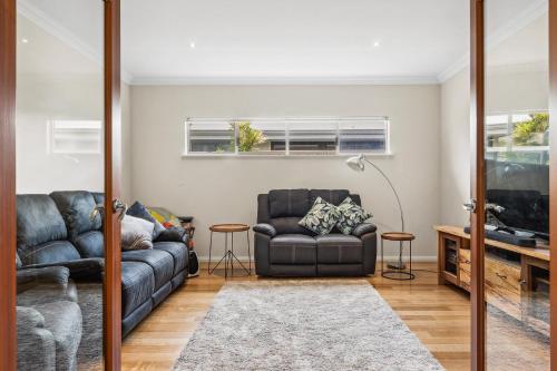 a living room with a couch and a tv at The Dunsborough Drift Family Holiday Home in Dunsborough
