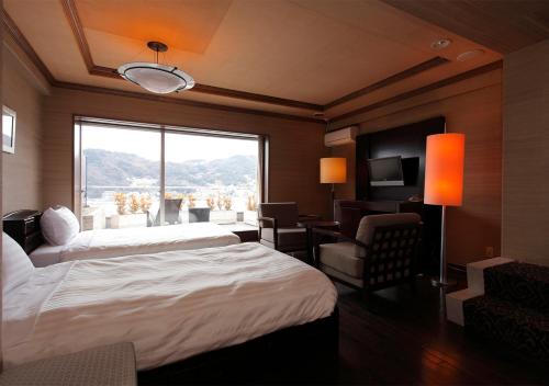 Кровать или кровати в номере Atami Season Hotel