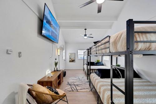 a living room with a bunk bed and a couch at Sleeps 17! Beach & Heated Pool, 10 minutes to all Tampa attraction! in Tampa