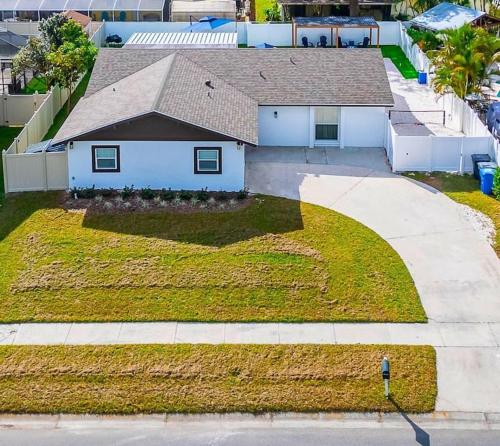 an aerial view of a house with a driveway at Sleeps 17! Beach & Heated Pool, 10 minutes to all Tampa attraction! in Tampa