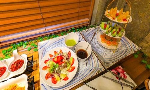 a table with plates of food and bowls of fruit at Hotel Yeogieutte Dongdaegu in Daegu