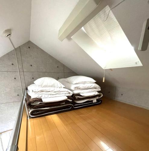 a pile of pillows sitting on the floor in a room at Amika First 303 AF33 in Tokyo