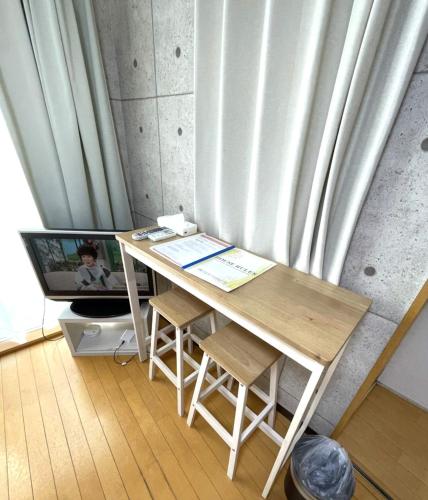 a desk in a room next to a curtain at Amika First 303 AF33 in Tokyo