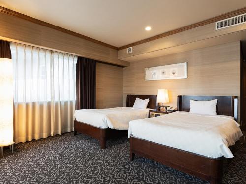 Кровать или кровати в номере Atami Season Hotel
