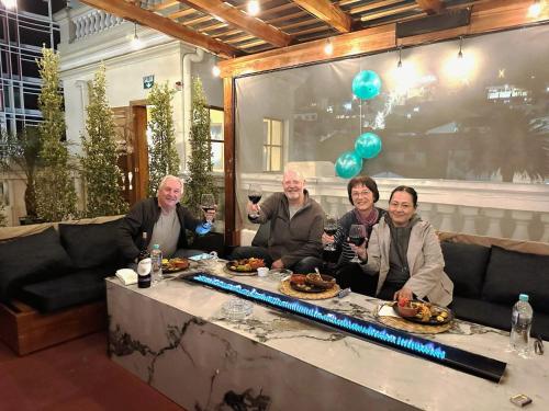 a group of people sitting at a table with wine glasses at Boutique Hotel in Quito Hotel Casona 1914 in Quito