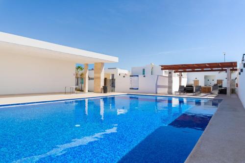 a swimming pool with blue water in front of a building at Casa Colibrí in La Paz