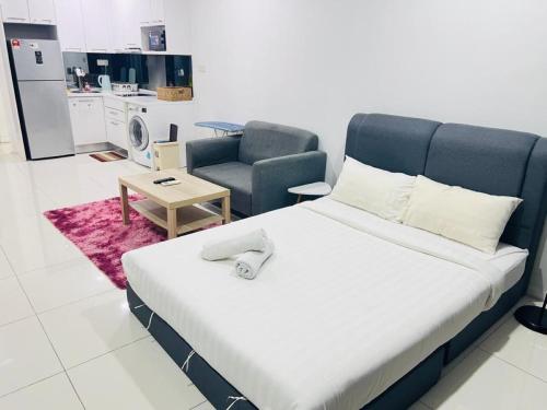 a bedroom with a bed and a couch and a chair at Mercu Summer Suites Kuala Lumpur Bukit Bintang By Classy in Kuala Lumpur