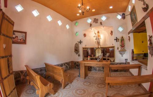 a room with a table and chairs in a room with windows at Hotel Hacienda Xico Inn in Xico