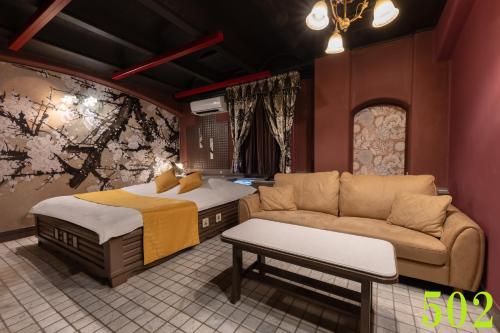 a living room with a couch and a bed at M'SCLUB OsakaHirano AdultOnly in Osaka