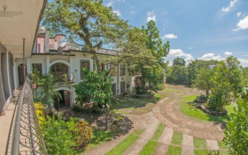 an exterior view of a house with a garden at Hotel Hacienda Xico Inn in Xico