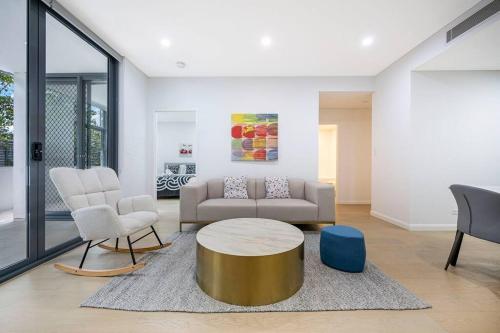 a living room with a couch and a table and chairs at Central Eastwood 3BR - Close to Shops & Transport in Sydney