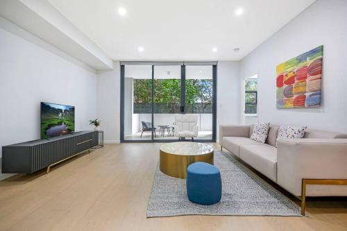 a living room with a couch and a table at Central Eastwood 3BR - Close to Shops & Transport in Sydney