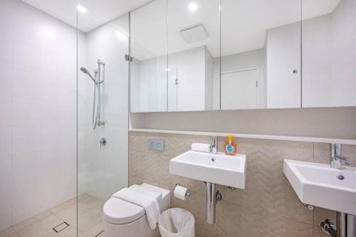 a bathroom with a toilet and a sink and a shower at Central Eastwood 3BR - Close to Shops & Transport in Sydney